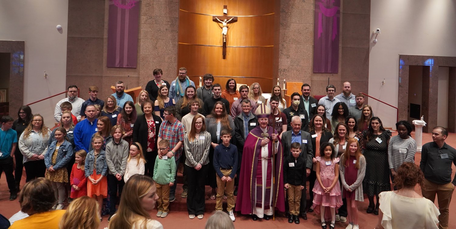The elect, who are preparing to be baptized at the Easter gather with Bishop W. Shawn McKnight in the sanctuary of Our Lady of Lourdes Church in Columbia on March 6, the First Sunday of Advent, following the Rite of Election and Call to Continuing Conversion.